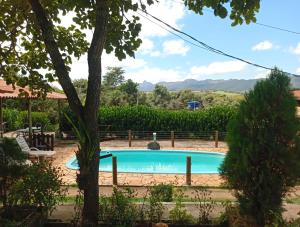 a swimming pool in a yard with a tree at Sitio Daniel in Mateus Leme