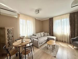 a living room with a couch and a table at Apart Mi in Novi Sad