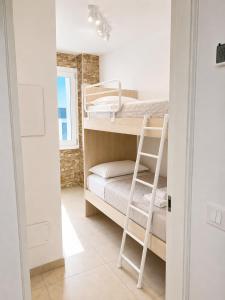 a room with a bunk bed and a ladder at Villa Gaspare in Lido di Jesolo