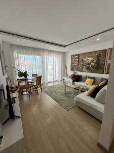 a living room with a couch and a table at Apartments Karmen Maria in Novigrad Istria
