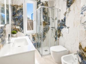 a bathroom with a shower and a toilet and a sink at Villa Gaspare in Lido di Jesolo +11 photos