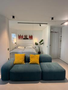 a bedroom with a blue couch with yellow pillows at Vacation Station Kamnik in Kamnik