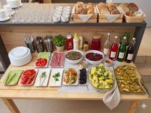 a table with a bunch of different types of food at Guest House Kobuleti 516 in Kobuleti