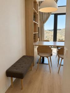 a dining room with a table and chairs and a window at Pirtelių resort - Mėlynasis namelis in Kiauleikiai
