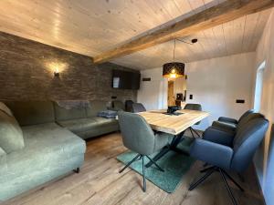 a dining room with a table and a couch at Ferienwohnung Loifried in Abtenau
