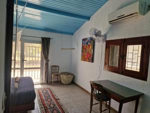 a room with a bedroom with a table and a bed at Beach House in Saly Portudal