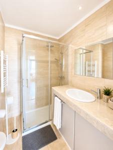 a bathroom with a shower and a sink at Lisbon Lux T1 Pool Gym Tennis AC - Pouso dos Anjos Apartment in Lisbon +13 photos