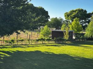 a field with a fence and a shed at Riesling Retreat in Cottonwood