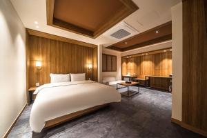 a bedroom with a large white bed and a bathroom at Hotel New Castle Bupyeong in Incheon +58 photos