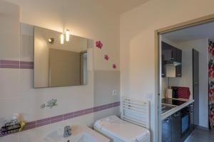 a bathroom with a toilet and a sink and a mirror at Résidence Château Saint Martin in Saint-Martin-dʼArdèche +12 photos