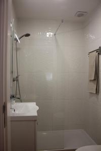 a white bathroom with a shower and a sink at TangoSierraResidences in Alcochete +58 photos