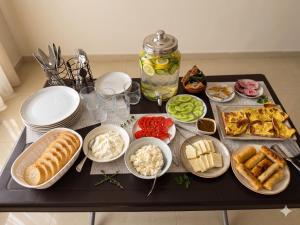 a table topped with plates and bowls of food at Guest House Kobuleti 516 in Kobuleti