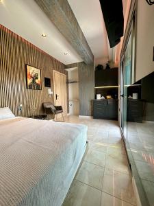 a bedroom with a large white bed in a room at Luxury Black and White Interior Apartments & Rooftop Terrace in Kalamata