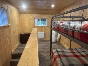 a small room with a bunk bed and a wooden floor at Spa Lake & Miller Zoo - Oppy Shack in Frampton