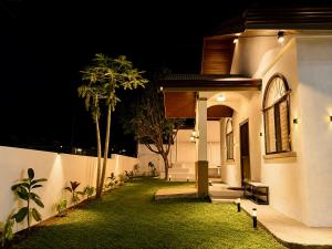 a small white house with a yard at night at DOS Unica Hija Hometel by TahZora in Valencia