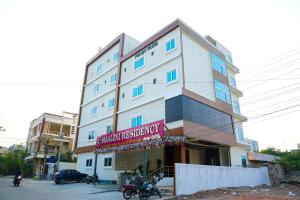 a large white building with a sign on it at Shalini Residency in Nalgonda