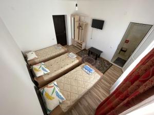 an overhead view of a room with two beds and a mirror at Guest House Arbat in Cholpon-Ata