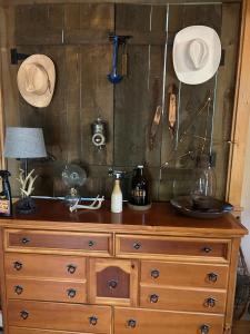 a wooden dresser with hats on top of it at Destiny Luxury Log Cabin in Sturgis +132 photos