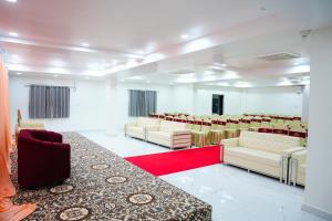 a conference room with chairs and a red carpet at Shalini Residency in Nalgonda