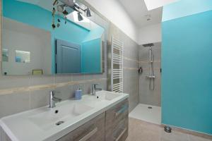 a bathroom with a sink and a mirror and a shower at Gîte de la Barrière in Sainte-Gemme +19 photos