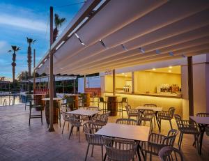 an outdoor patio with tables and chairs at Fun Sun Smart Lurea Beach in Kemer