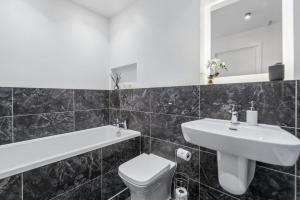 a bathroom with a sink and a toilet and a mirror at Windsor Castle Views - Spacious Flat - By Tempstay in Windsor +10 photos