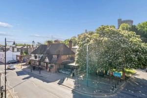 an empty street in a town with a large tree at Windsor Castle Views - Spacious Flat - By Tempstay in Windsor