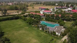 an aerial view of a resort with a swimming pool at The Corbett Manral Resort in Rāmnagar
