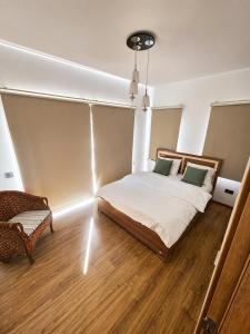 a bedroom with a bed and a chair in it at Bellapais Stone Villa in Kyrenia