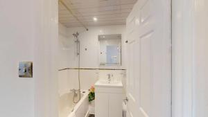 a white bathroom with a toilet and a sink at Buckland Mews in Abingdon +17 photos