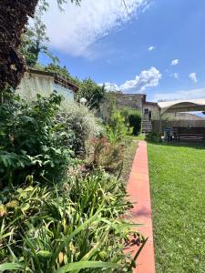a garden with a red brick walkway at Villa Artemide - Ospitalità nel Borgo in Marsico Vetere