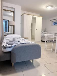 a bedroom with a bed and a table and a mirror at Smart-Apartment in Bamberg in Bamberg