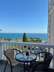 a table and chairs on a balcony with the ocean at Apartments Adriatik in Ulcinj +34 photos