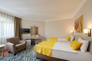 a hotel room with a bed and a chair at Fun Sun Smart Lurea Beach in Kemer