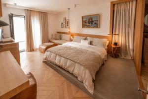 a bedroom with a large bed and a couch at Mamei Boutique Villa in Dobrota +97 photos