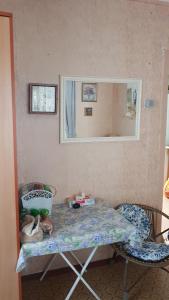 a room with a table and two chairs and a mirror at Dacha Pool and Grill in Karavan +20 photos