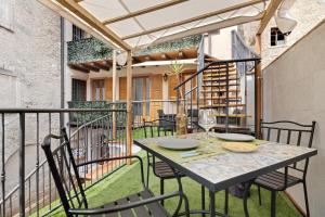 a patio with a table and chairs on a balcony at Casa Sole in Ceniga