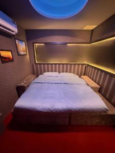 a bedroom with a large bed in a room at Holy Hostel Sukhumvit 22 in Bangkok