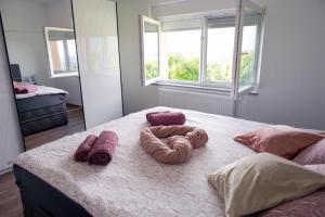 a bedroom with a bed with two towels on it at Kuća za odmor Serdar in Slavonski Brod