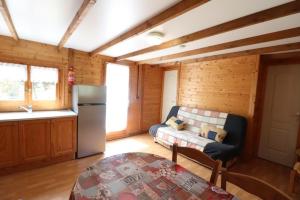 a living room with a couch and a refrigerator at Camping de Saint Just - Onlycamp in Arcomie +16 photos
