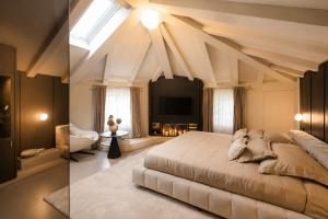 a bedroom with a large bed and a skylight at La Villa Residence in Rovinj