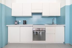 a white kitchen with a sink and a dishwasher at Maréa apartments - Sul mare 2 in Alba Adriatica