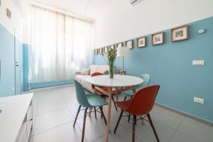 a living room with a table and chairs at Maréa apartments - Sul mare 2 in Alba Adriatica +10 photos