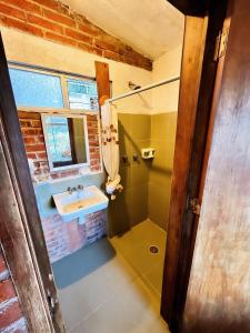a bathroom with a sink and a shower at La Misión Cabañas Chignahuapan in Chignahuapan +39 photos