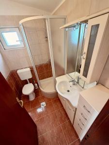 a bathroom with a sink and a toilet and a shower at Villa Ocean Breeze First Row in Brist +33 photos