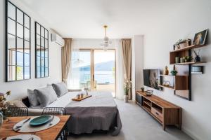 a living room with a bed and a table at Anna Luxury BELLA VISTA in Baošići