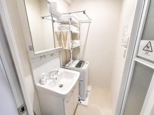 a bathroom with a sink and a washing machine at New Entire Family House 1 Min to Metro Umeda Direct in Osaka +20 photos