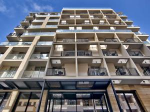 an apartment building with balconies on the side at Number 11 St Julian's Malta - Handwritten Collection in St. Julianʼs