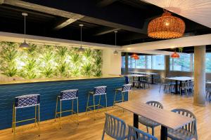 a restaurant with tables and chairs and a wall with plants at Vadamar Hotel Collection Rodadero in Gaira