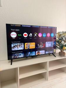 a large flat screen tv sitting on top of a shelf at New Entire Family House 1 Min to Metro Umeda Direct in Osaka
